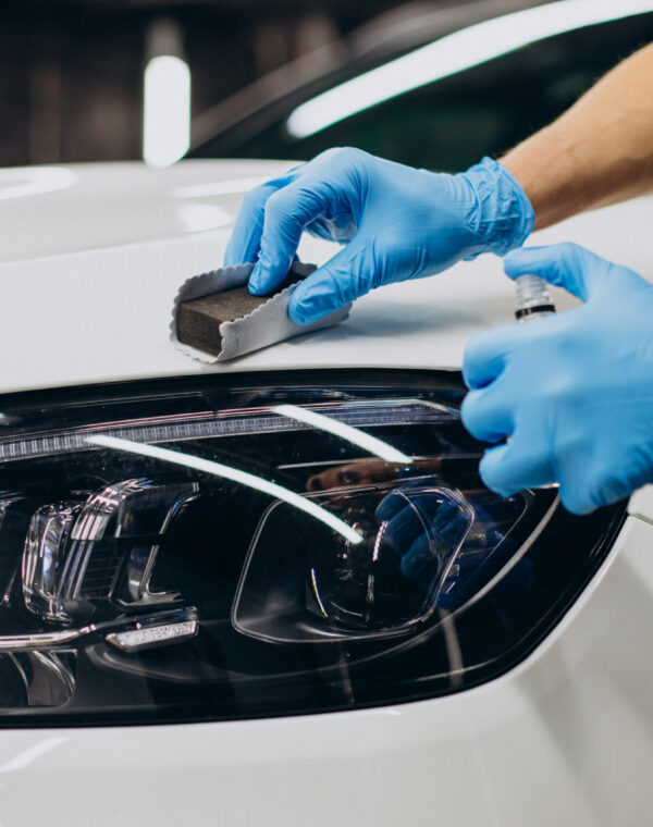 Man working car detailing and coating car